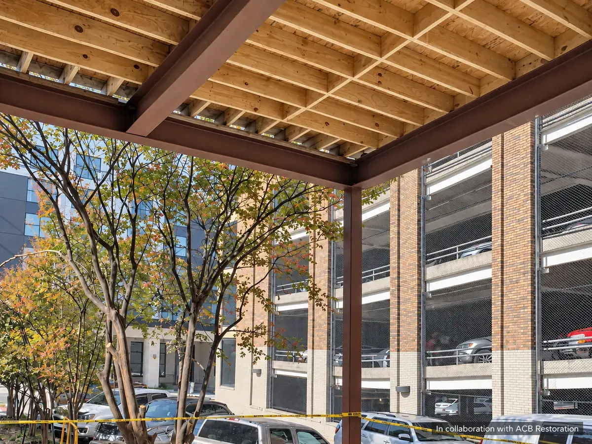 Exposed steel beams and wood ceiling joists showing framing connections during construction. In collaboration with ACB Restoration.